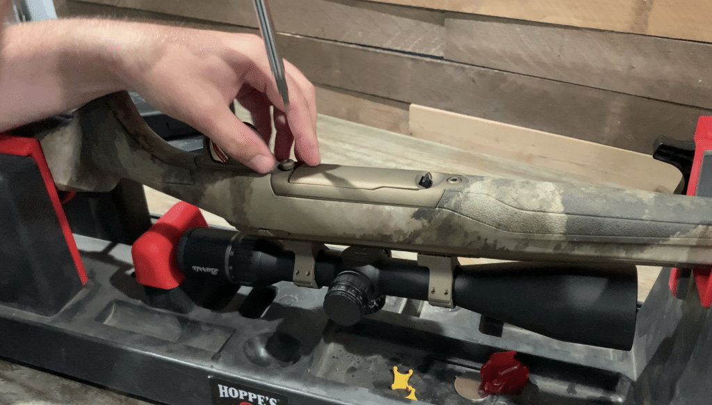 The bottom of a Browning X-Bolt Hell's Canyon Speed rifle showing the bottom metal and magazine being removed by a gunsmith on a Hoppe's 9 gun vice.